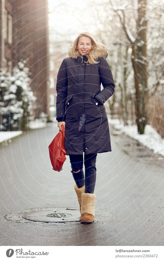 Attractive young blond woman in warm winter coat Lifestyle Happy Beautiful Face Winter Snow Woman Adults 1 Human being 45 - 60 years Park Street Fashion Coat