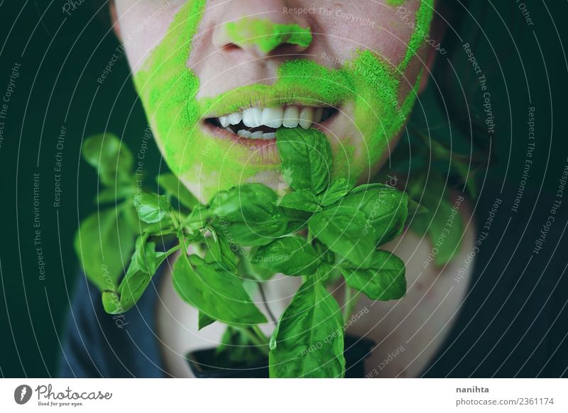 Young woman biting a basil leaf Food Vegetable Basil Nutrition Eating Organic produce Vegetarian diet Style Design Exotic Skin Face Human being Feminine