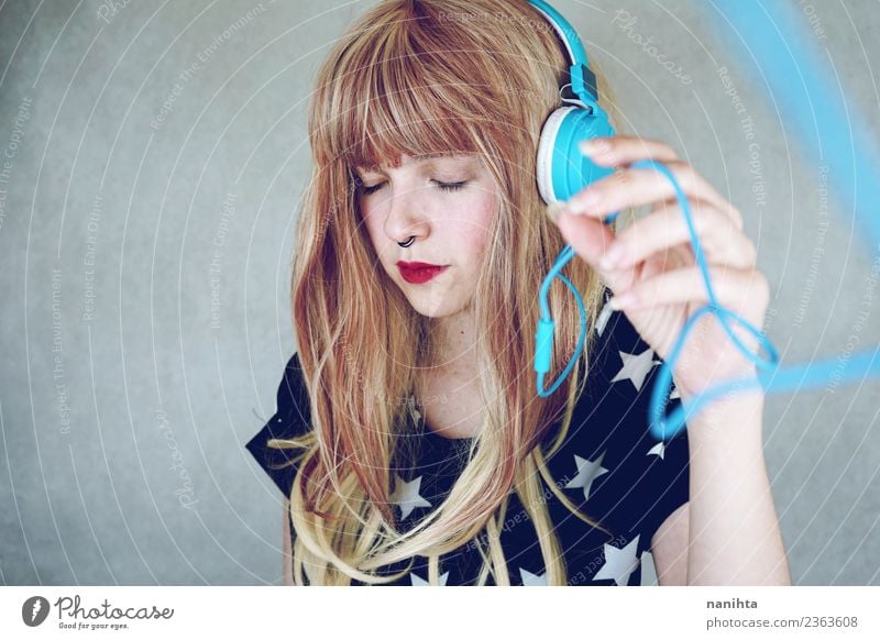 Young woman listening to music Lifestyle Style Design Beautiful Hair and hairstyles Senses Relaxation Leisure and hobbies Headset Technology