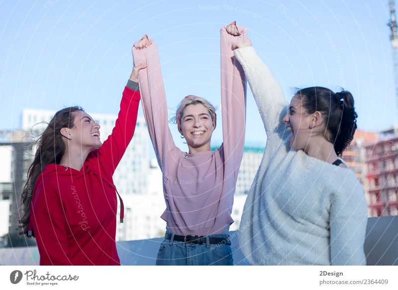 Three happy excited young adult women in casual dresses celebrate victory and jumping Lifestyle Joy Happy Summer Success School Academic studies Computer