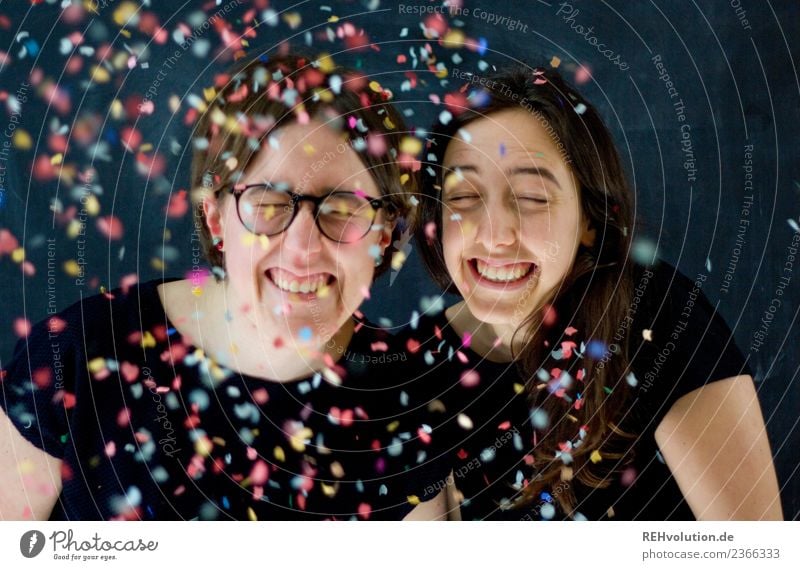 Portrait of two laughing women with confetti Lifestyle Party Feasts & Celebrations Human being Feminine Young woman Youth (Young adults) Woman Adults