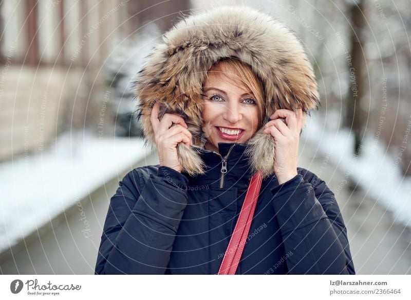 Portrait of smiling woman wearing winter hood Lifestyle Happy Beautiful Face Winter Snow Woman Adults 1 Human being 45 - 60 years Park Fashion Coat Fur coat