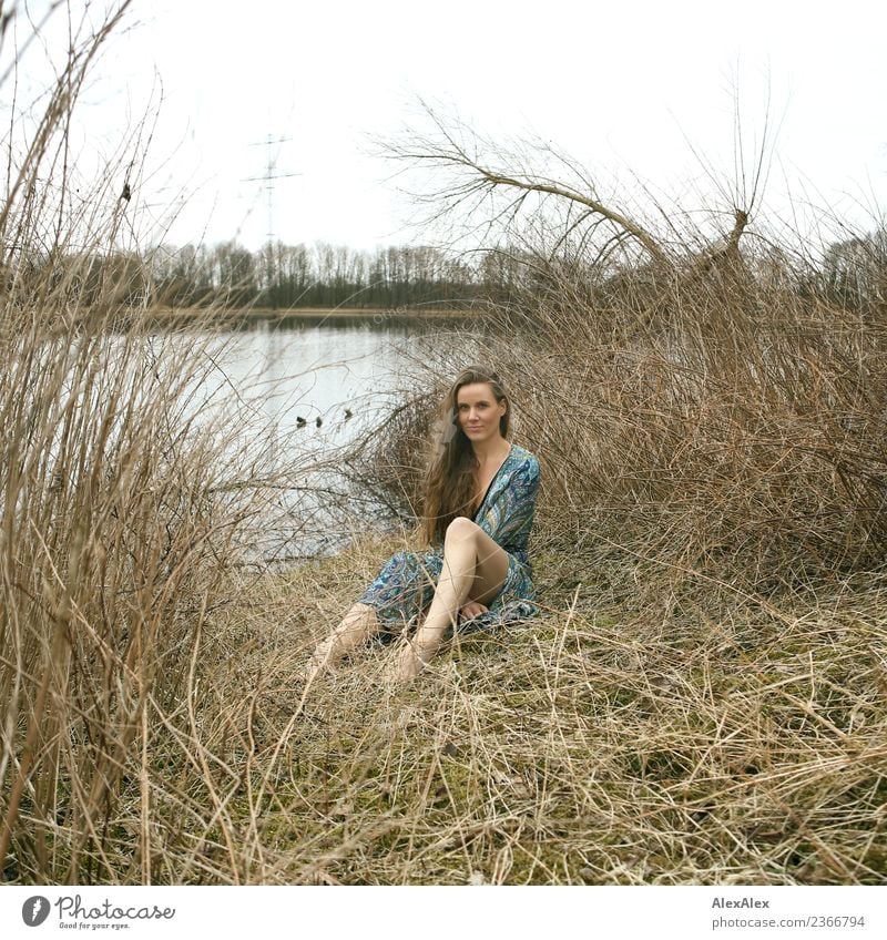 analog medium format portrait of young woman in summer dress sitting barefoot among bushes in nature on a lakeside Joy pretty Life Harmonious Young woman