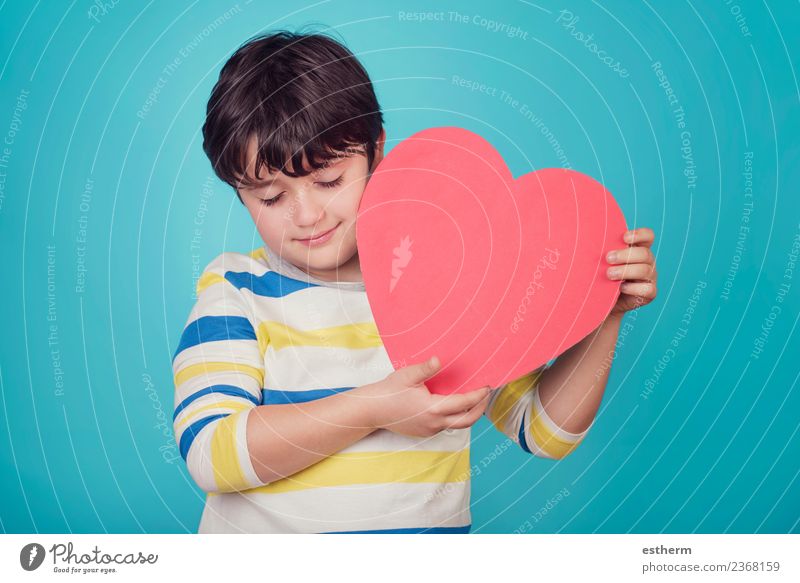 smiling boy with a heart on blue background Lifestyle Joy Party Event Feasts & Celebrations Valentine's Day Mother's Day Human being Masculine Child Toddler