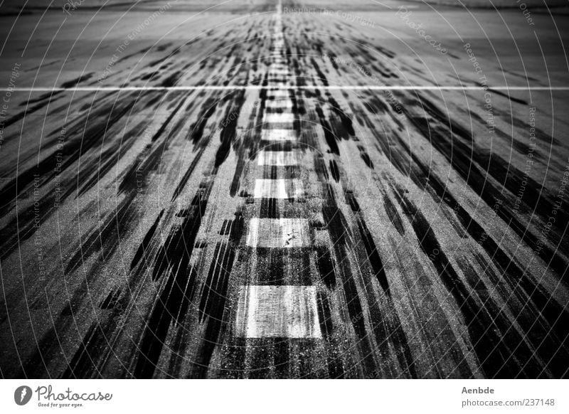 runway Transport Airport Runway Esthetic Skid marks Marker line Airplane landing Airplane takeoff Black & white photo Exterior shot Deserted Day Exceptional