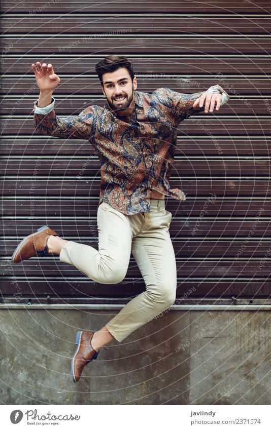 Young bearded man jumping in urban background Joy Feasts & Celebrations Human being Young man Youth (Young adults) Man Adults 1 18 - 30 years Autumn Street