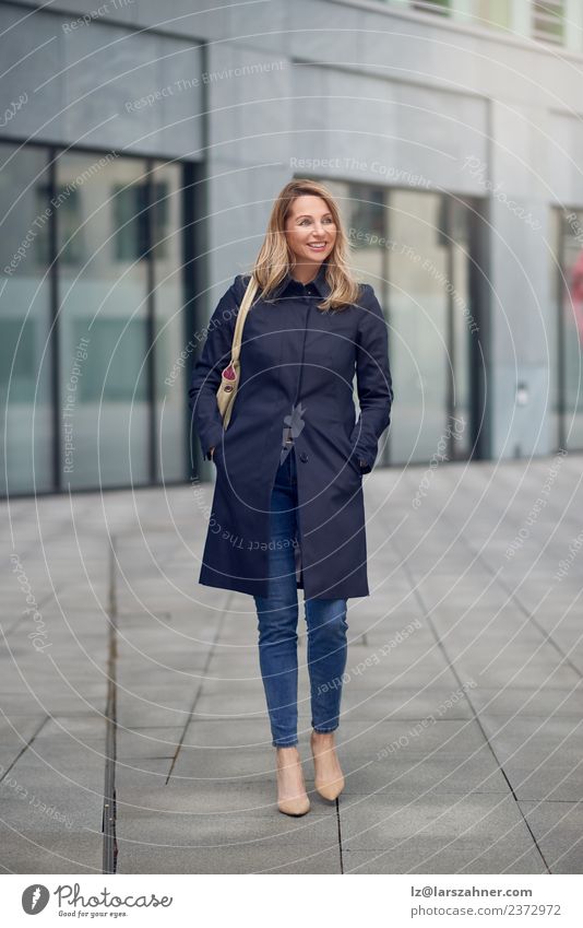 Attractive woman in jeans and an overcoat Style Happy Beautiful Work and employment Office Business Career Woman Adults 1 Human being 45 - 60 years Building