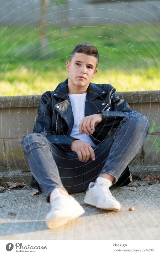Young male sitting outdoors wearing black leather jacket. Style Human being Masculine Boy (child) Young man Youth (Young adults) Man Adults 1 13 - 18 years
