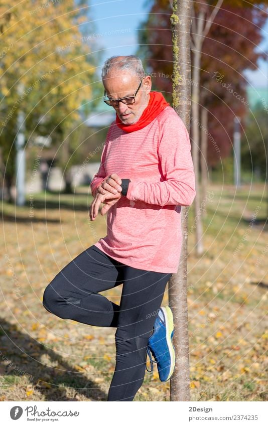 Portrait of a senior man using a smart watch. Lifestyle Wellness Relaxation Sports Jogging Work and employment Screen Technology Human being Feminine Man Adults