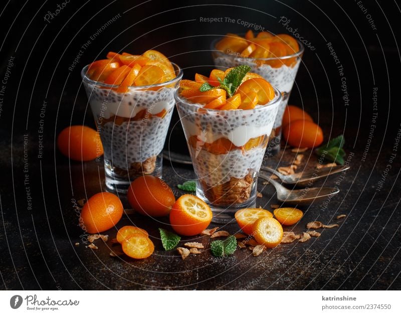Chia pudding parfait, layered with kumquat and granola Yoghurt Fruit Dessert Eating Breakfast Diet Bowl Spoon Dark Bright Green White Colour Cereal chia Pudding