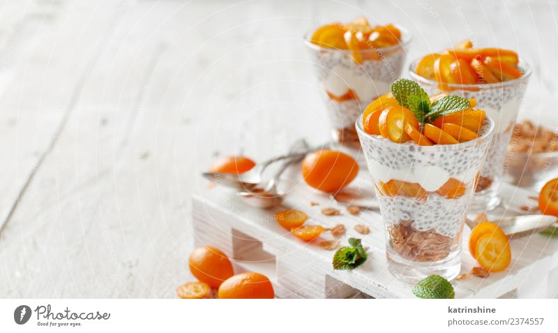 Chia pudding parfait, layered with kumquat and granola Yoghurt Fruit Dessert Eating Breakfast Diet Bowl Spoon Bright Green White Colour Cereal chia Pudding seed