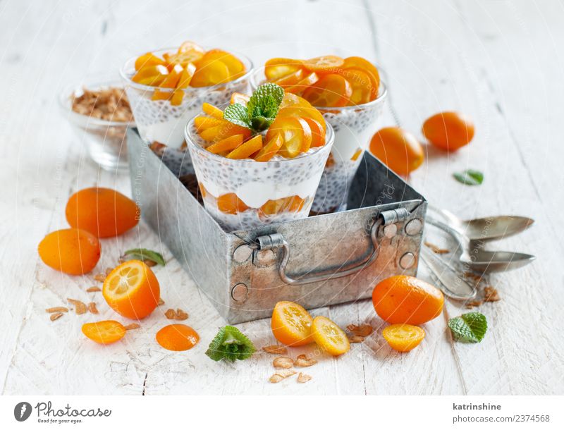 Chia pudding parfait, layered with kumquat and granola Yoghurt Fruit Dessert Eating Breakfast Diet Bowl Spoon Metal Bright Green White Colour Cereal chia
