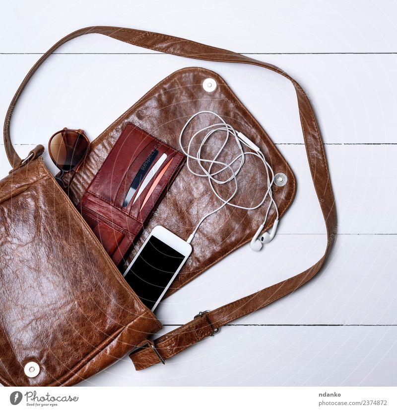 open female brown leather bag Elegant Style Design PDA Screen Fashion Leather Accessory Sunglasses Modern Brown Black White Colour Headphones device cord purse