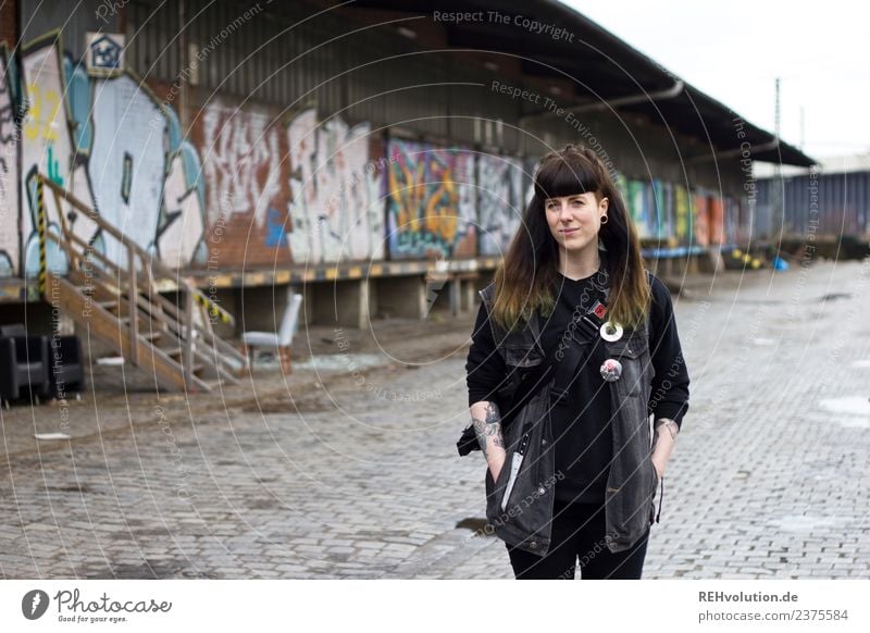 young woman stands on an old industrial site with graffiti Young woman Looking into the camera Cool hip Guy Character Hamburg 18 - 30 years Hair and hairstyles