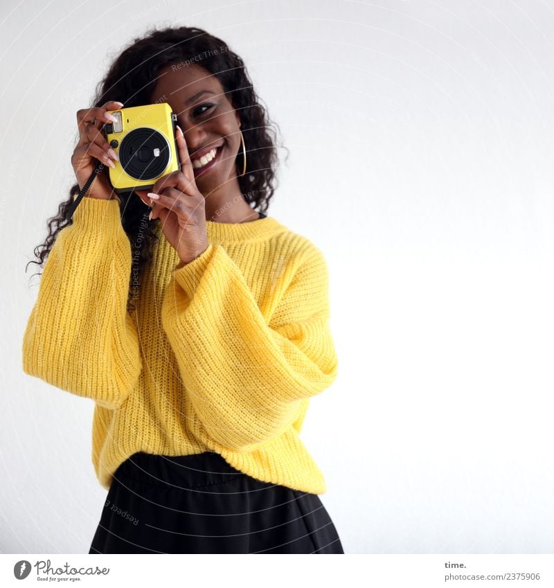 Apolline Feminine Woman Adults 1 Human being Skirt Sweater Earring Black-haired Long-haired Curl Camera Observe Smiling Laughter Looking Stand Beautiful Yellow