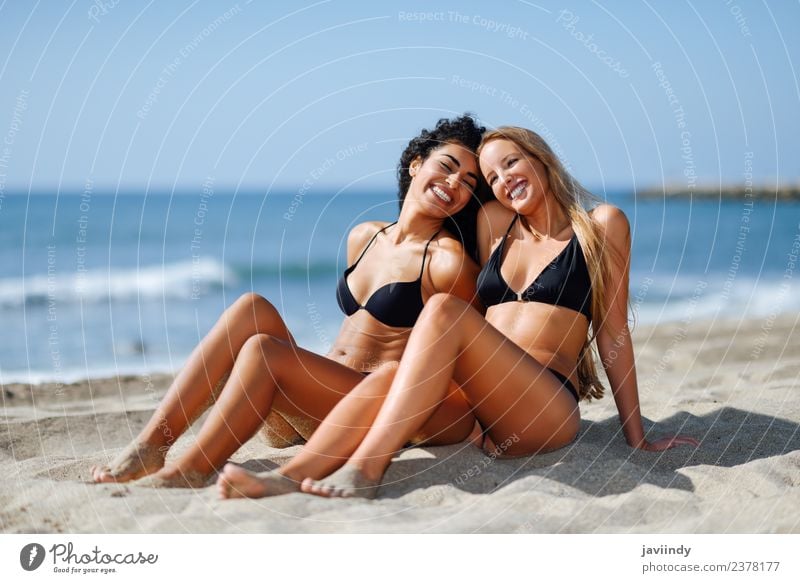 Two women in bikini sitting on a tropical beach sand Lifestyle Joy Beautiful Body Leisure and hobbies Vacation & Travel Tourism Summer Beach Ocean Human being