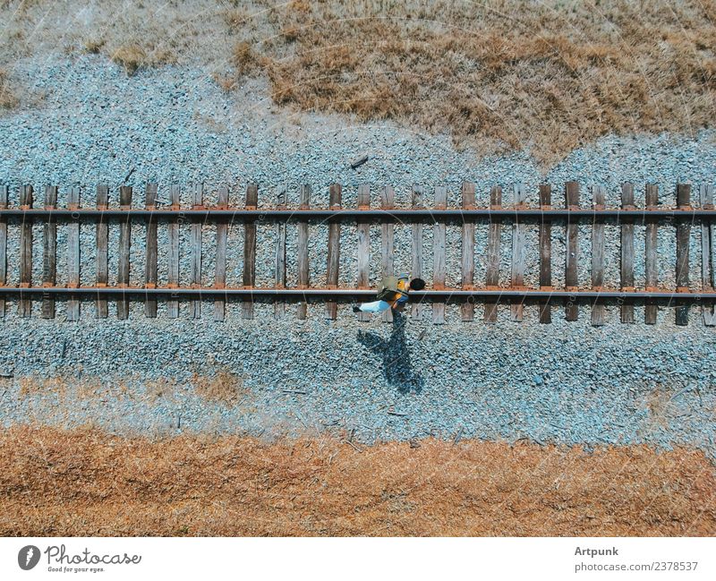 An aerial view of a hiker walking along the railroad Railroad Hiking Steel Industrial Transport Exterior shot Adventure Vacation & Travel Gravel Aircraft Drone