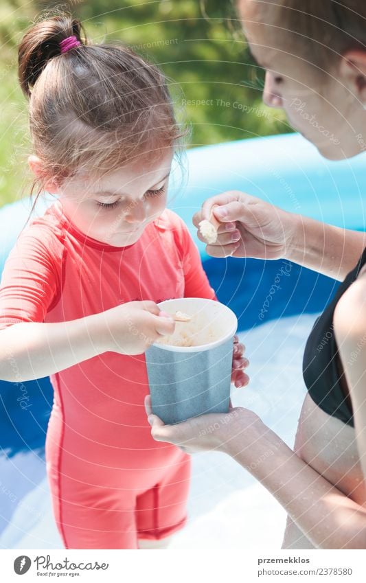 Teenage girl with her little sister spending time together Dessert Ice cream Eating Lifestyle Joy Happy Beautiful Swimming pool Leisure and hobbies