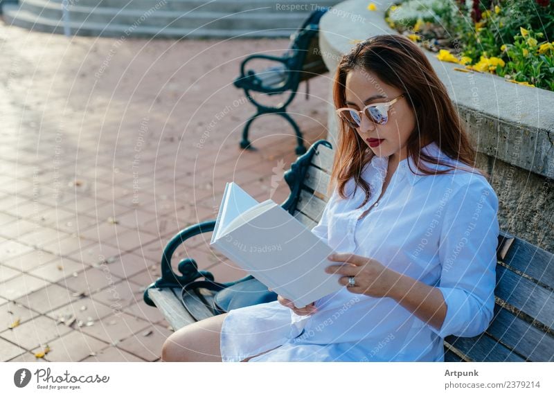 Young Asian woman reading a book Book bibliophile Reading White Shirt Bench Park Education School Literature Sit Sunglasses Word Binding Relaxation