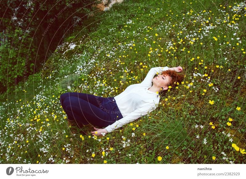 Young woman resting in a field of flowers Lifestyle Joy Healthy Wellness Harmonious Senses Relaxation Calm Meditation Vacation & Travel Adventure Freedom
