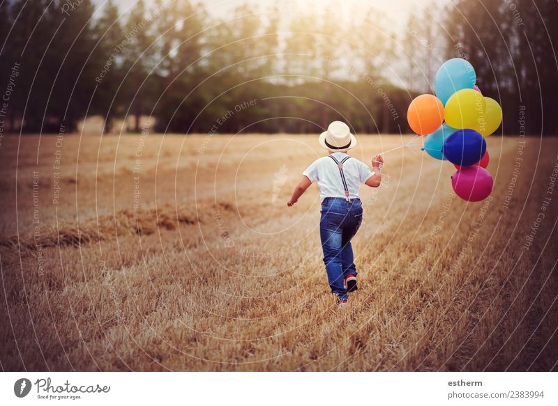 boy running through the field with balloons Lifestyle Joy Vacation & Travel Trip Adventure Freedom Entertainment Party Feasts & Celebrations Birthday Masculine
