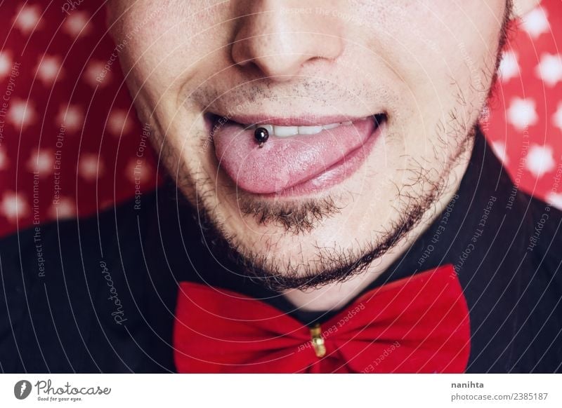 Young man sticking out his tongue Lifestyle Elegant Style Joy Face Entertainment Party Event Feasts & Celebrations Human being Masculine Youth (Young adults)