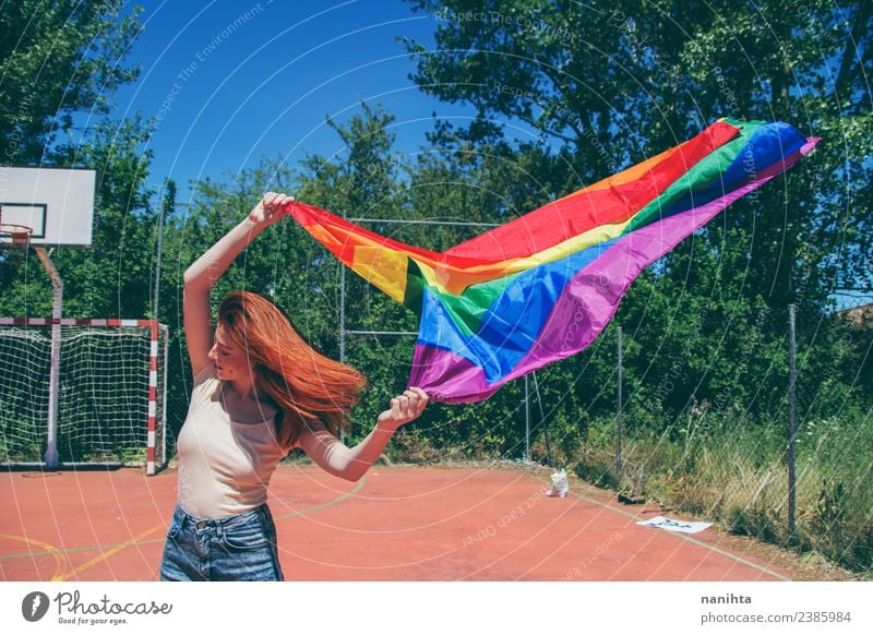 Young woman waving a rainbow flag Lifestyle Style Design Schoolyard Student Human being Feminine Homosexual Young man Youth (Young adults) 1 18 - 30 years