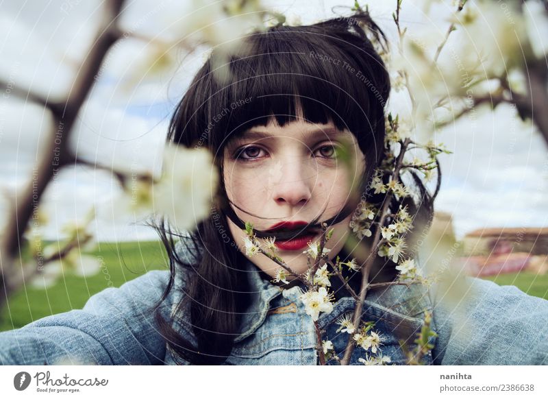 Young brunette woman surrounded by flowers Lifestyle Style Design Beautiful Hair and hairstyles Skin Face Human being Feminine Young woman Youth (Young adults)