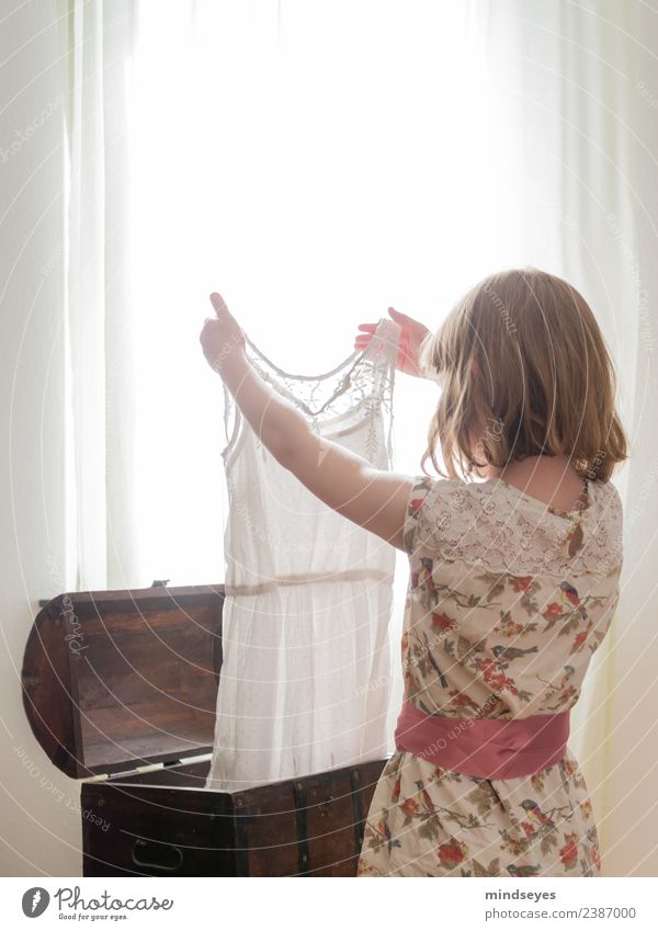 Girl looks at dress against light from window Feminine Infancy 1 Human being 3 - 8 years Child Window Dress Chest Blonde Box Looking Stand Dream Growth Bright