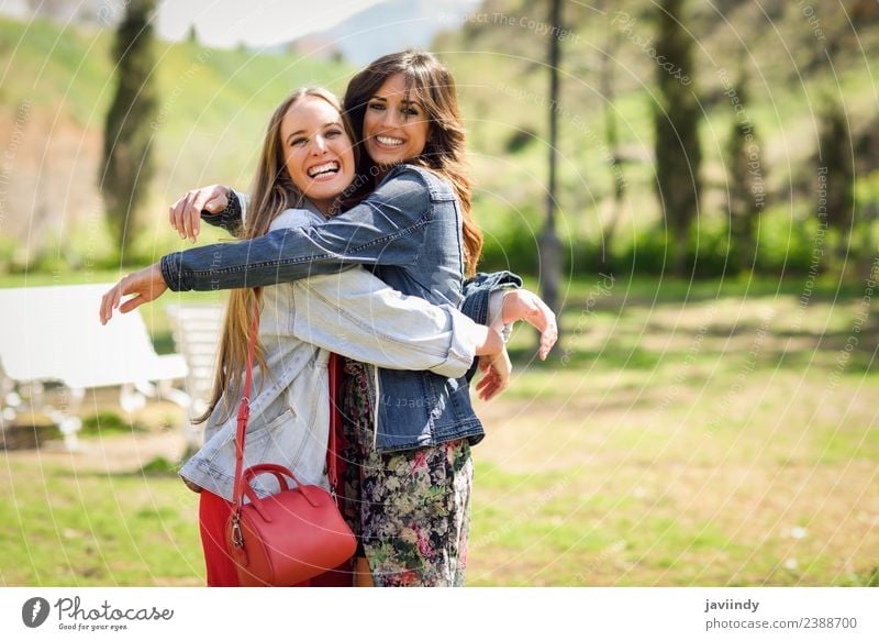 Two happy girls hugging in urban park. Lifestyle Style Joy Happy Beautiful Human being Feminine Young woman Youth (Young adults) Woman Adults Friendship 2