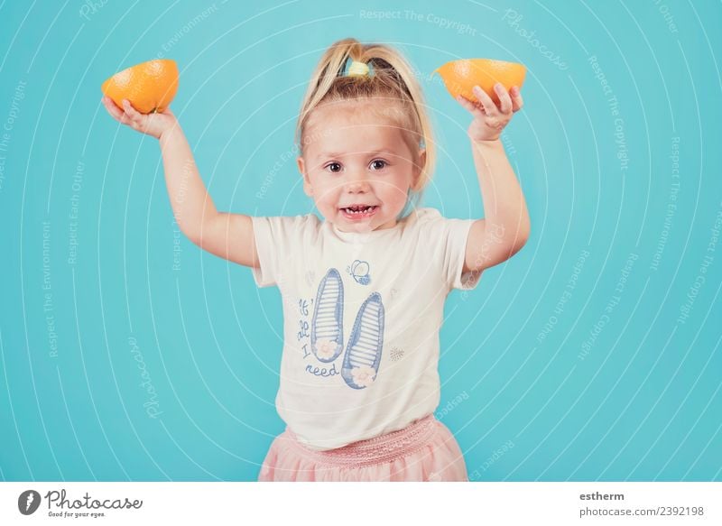 smiling baby with an orange on blue background Food Fruit Orange Nutrition Eating Lunch Lifestyle Joy Healthy Eating Human being Feminine Baby Girl Infancy 1