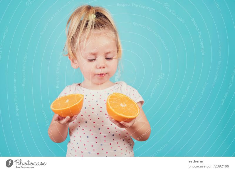 baby eating an orange on blue background Food Fruit Orange Nutrition Eating Lunch Lifestyle Joy Healthy Eating Human being Feminine Baby Girl Infancy 1
