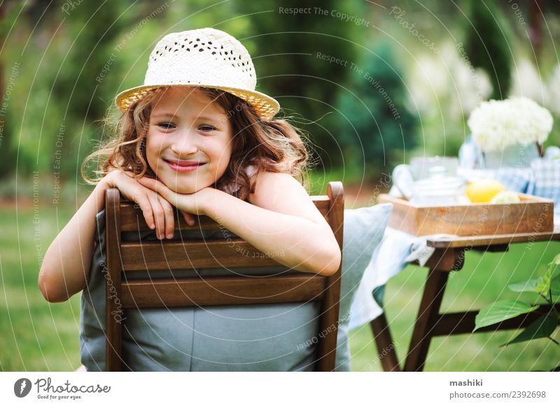 happy child girl in hat enjoying summer Breakfast Tea Joy Happy Leisure and hobbies Playing Vacation & Travel Summer Garden Decoration Chair Table Child Nature