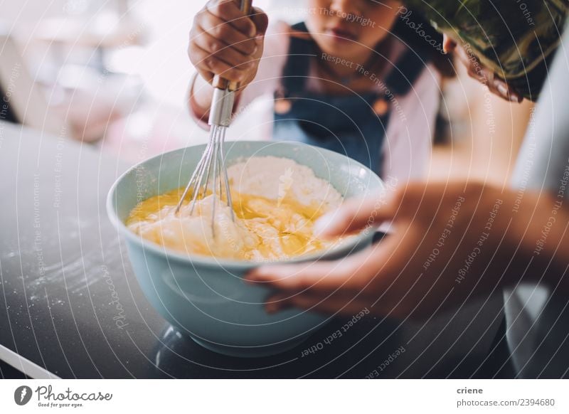 close up of child mixing ingredients for cake in bowl Dessert Bowl Lifestyle Happy Kitchen Child School Woman Adults Family & Relations Together Small cooking