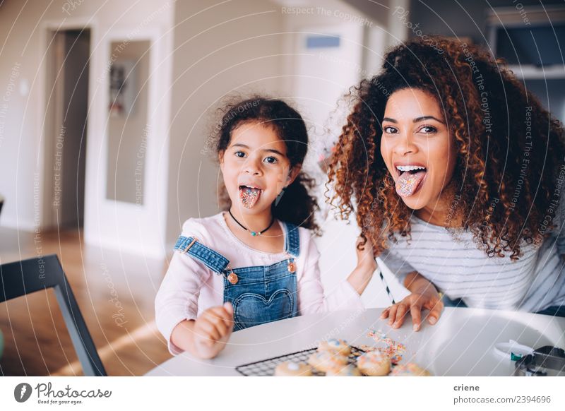 Mother and daughter pulling funny face in kitchen Eating Joy Happy Kitchen Child Woman Adults Family & Relations Infancy Smiling Love Happiness Delicious Funny