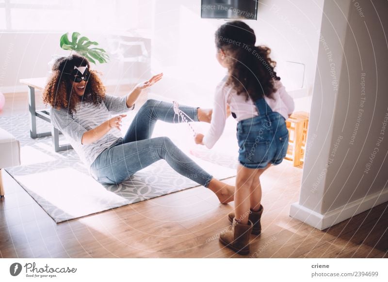 mother and daughter playing in living room with costumes Joy Happy Playing Child Parents Adults Mother Family & Relations Infancy Laughter Happiness Together