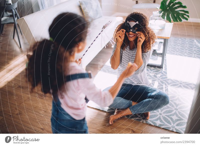 mother and daughter having fun with cat costume in living room Joy Happy Playing Living room Child Parents Adults Mother Family & Relations Infancy Laughter