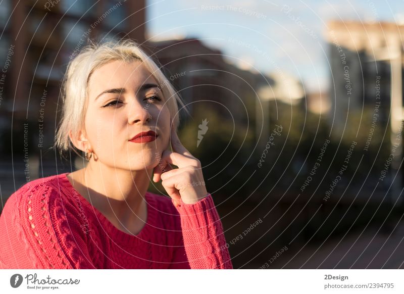Portrait of a young blonde woman gesturing in the street wearing a red sweeter Lifestyle Happy Beautiful Face Human being Feminine Young woman