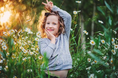 happy kid girl fooling in summer Joy Happy Beautiful Face Playing Vacation & Travel Summer Sun Child Woman Adults Infancy Nature Weather Warmth Flower Grass