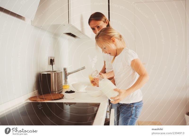 mother having breakfast with kid daughter at home Breakfast Lifestyle Joy Happy Kitchen Child Mother Adults Family & Relations Smiling Embrace Together Modern