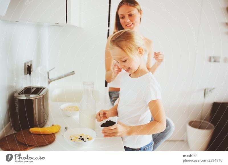 mother having breakfast with kid daughter Breakfast Lifestyle Joy Happy Kitchen Child Mother Adults Family & Relations Smiling Embrace Together Modern White