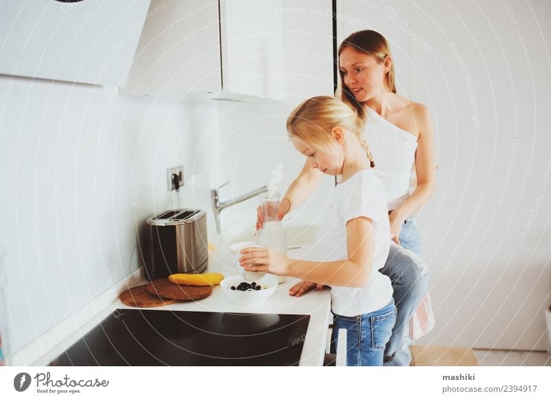 mother having breakfast with kid daughter Breakfast Lifestyle Joy Happy Kitchen Child Mother Adults Family & Relations Smiling Embrace Together Modern White