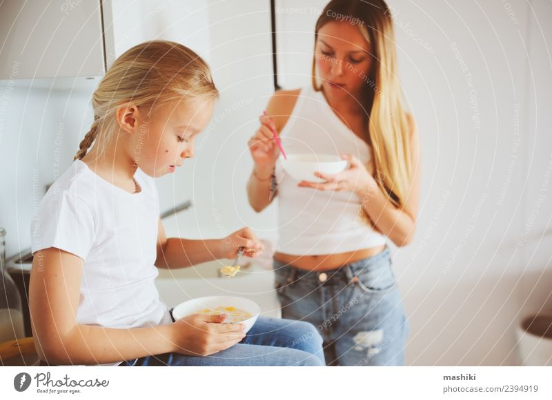 mother having breakfast with daughter Breakfast Lifestyle Joy Happy Kitchen Child Mother Adults Family & Relations Smiling Embrace Together Modern White