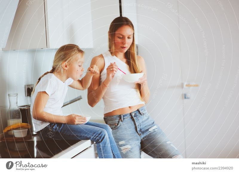 mother having breakfast with daughter Breakfast Lifestyle Joy Happy Kitchen Child Mother Adults Family & Relations Smiling Embrace Together Modern White