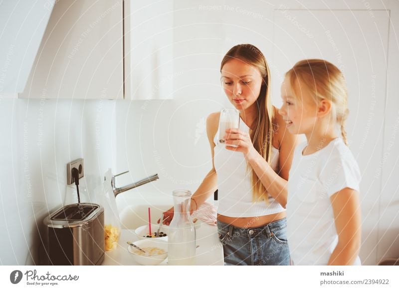 mother having breakfast with kid Breakfast Lifestyle Joy Happy Kitchen Child Mother Adults Family & Relations Smiling Embrace Together Modern White Relationship