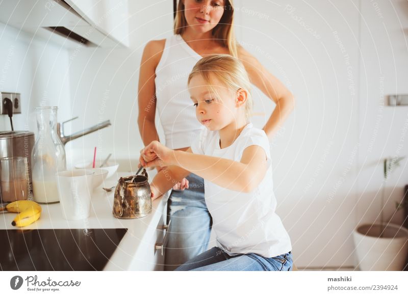 mother having breakfast with kid Breakfast Lifestyle Joy Happy Kitchen Child Mother Adults Family & Relations Smiling Embrace Together Modern White Relationship