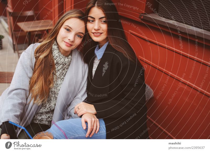 two happy girl friends talking Coffee Lifestyle To talk Feminine Woman Adults Friendship Autumn Weather Street Sweater Coat Smiling Laughter Together
