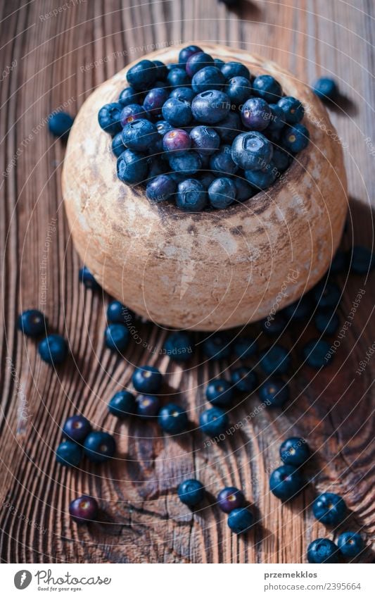 Freshly gathered blueberries put into old ceramic bowl Food Fruit Nutrition Organic produce Vegetarian diet Diet Bowl Summer Table Nature Wood Authentic