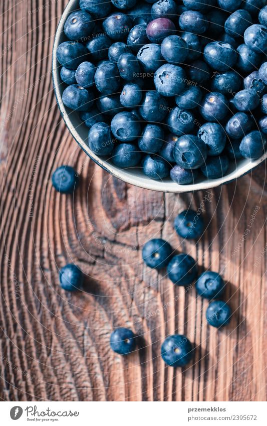 Freshly gathered blueberries put into ceramic bowl Food Fruit Nutrition Organic produce Vegetarian diet Diet Bowl Summer Table Nature Wood Authentic Delicious