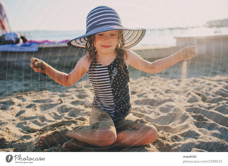 happy child relaxing on summer beach Lifestyle Joy Vacation & Travel Summer Sun Beach Child Infancy Sand Warmth Coast Hat Stripe To enjoy Smiling Wet Natural